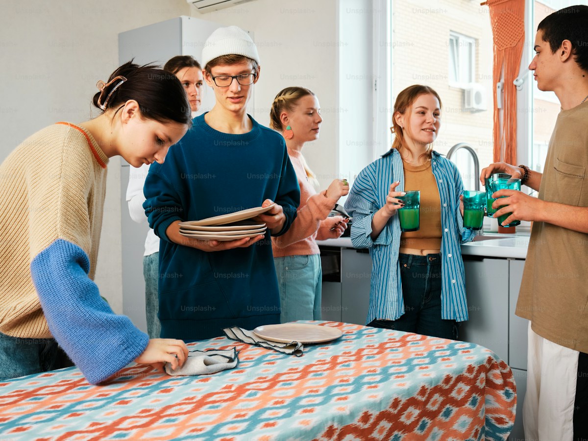 a group of people standing around a table